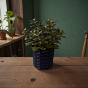 A dark navy 3D-printed chevron planter holding a 4-inch succulent, sitting on a wooden table with houseplants blurred in the background